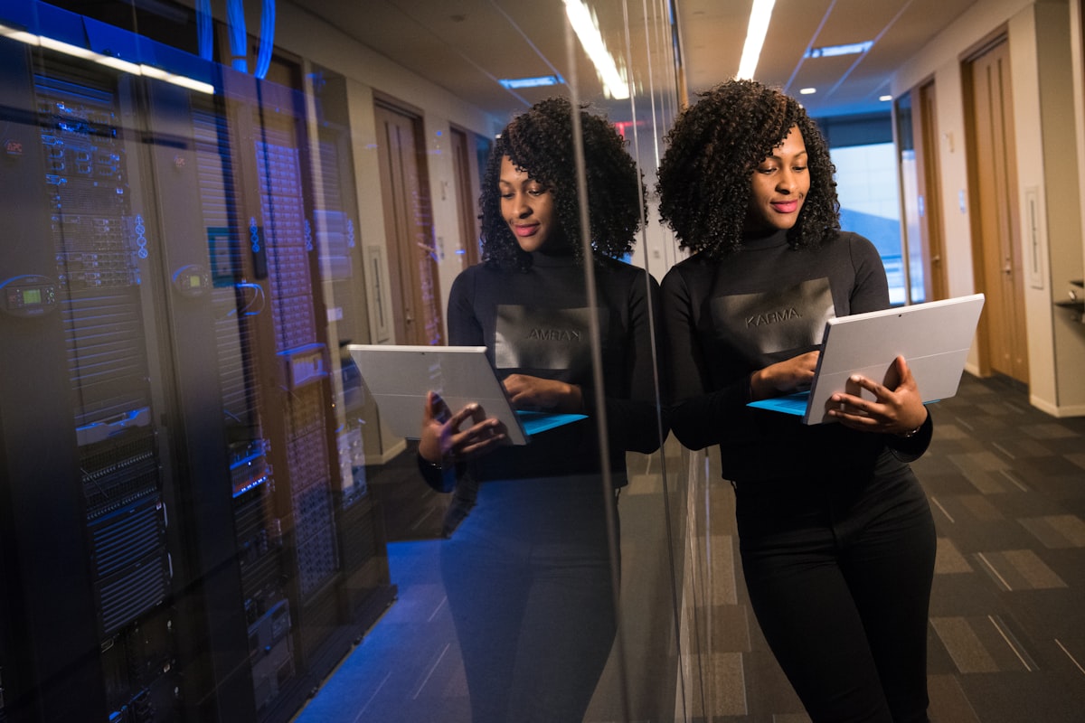 Business owner reviewing AI automation tools on a laptop with charts showing workforce transformation data