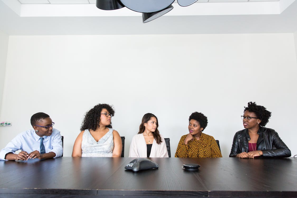 Team members collaborating on laptop screens with chat interface — best Slack alternatives comparison