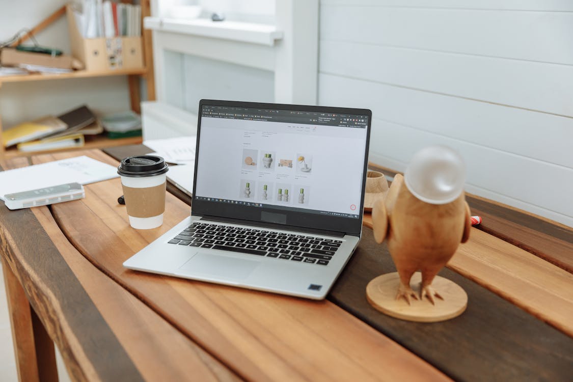Small business owner reviewing website design quotes on a laptop — website design cost planning